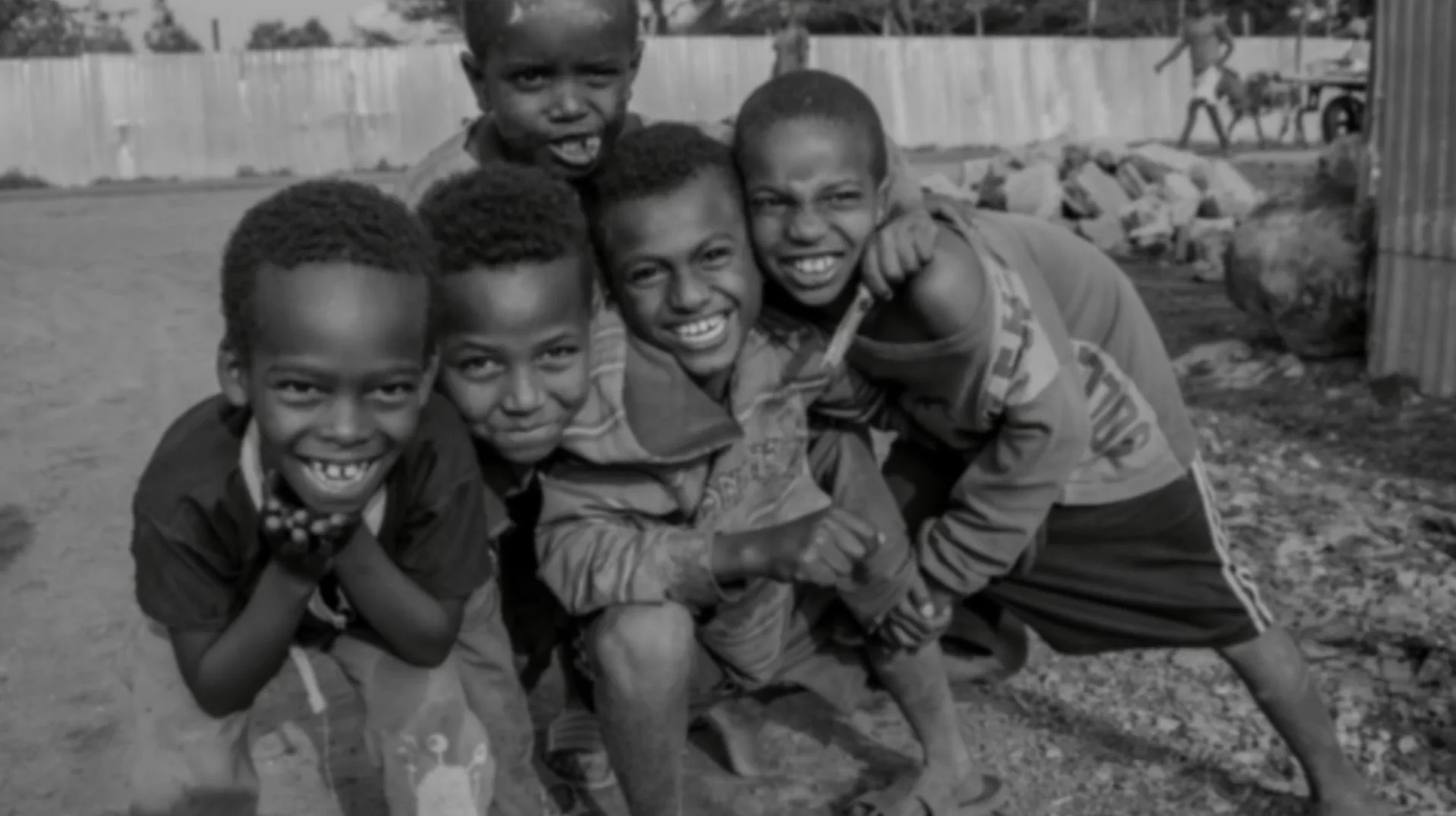 A group of children smiling and laughing together